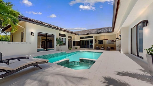 view of swimming pool with an in ground hot tub and a patio area