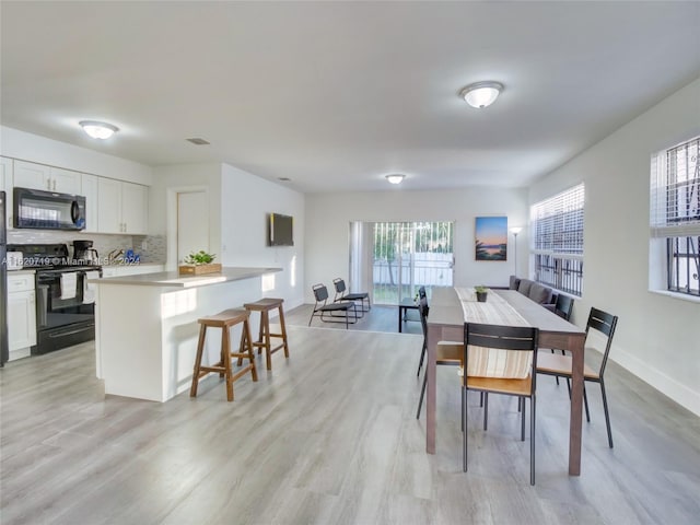 dining room with light hardwood / wood-style flooring