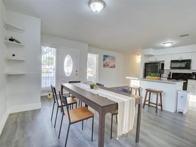 dining area with light hardwood / wood-style flooring