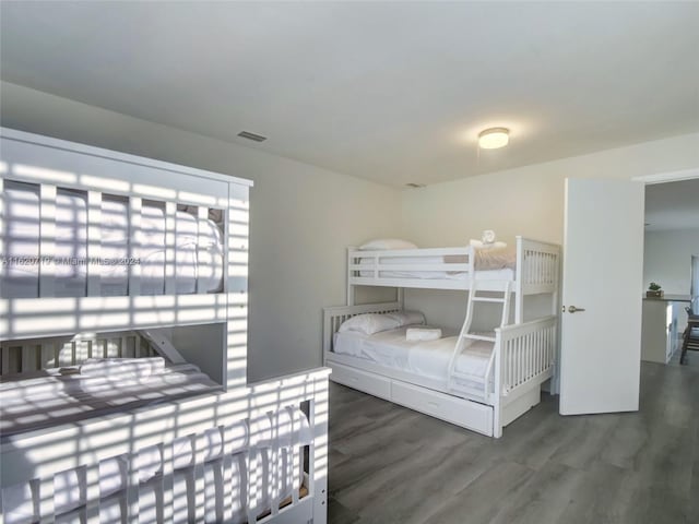 bedroom with dark wood-type flooring