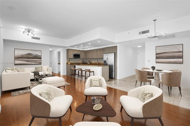 living room featuring an inviting chandelier and tile patterned flooring