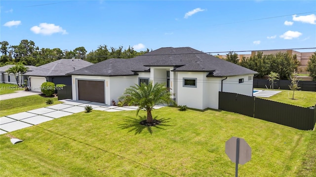 view of front of home featuring a garage and a front yard