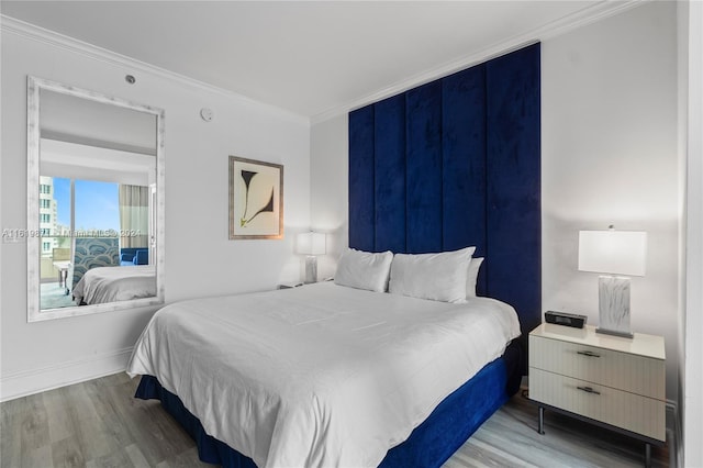 bedroom featuring hardwood / wood-style floors and ornamental molding