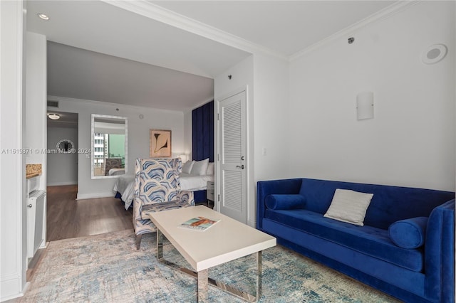 living room featuring crown molding and hardwood / wood-style flooring