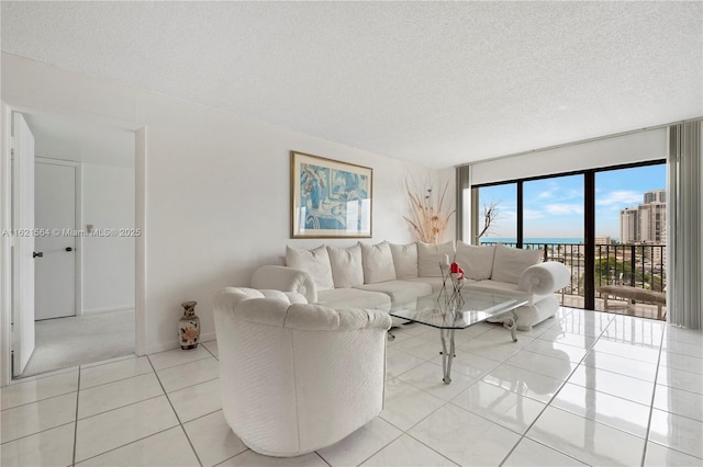 living area featuring light tile patterned floors and a textured ceiling