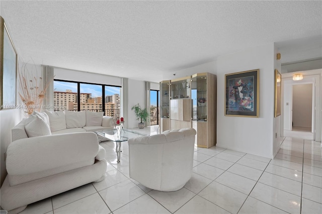 living room with a textured ceiling and light tile patterned floors