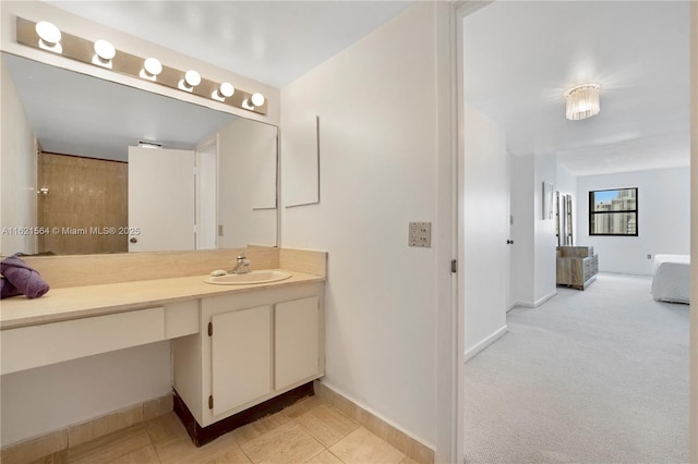 bathroom with vanity, baseboards, and tile patterned floors