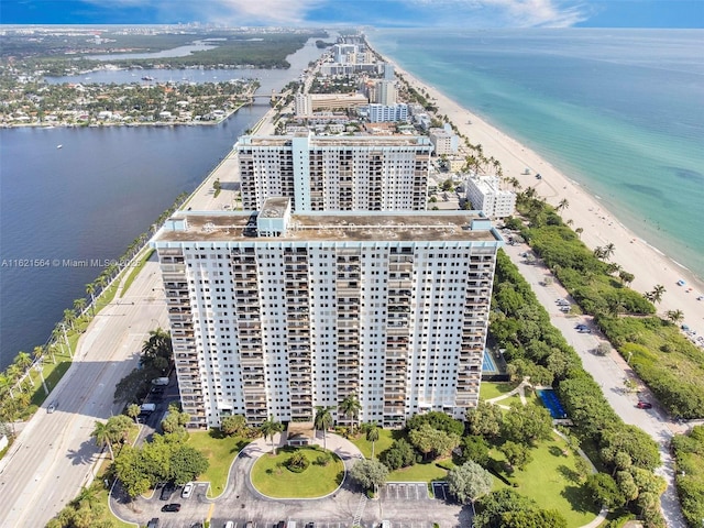 drone / aerial view featuring a view of city, a water view, and a view of the beach