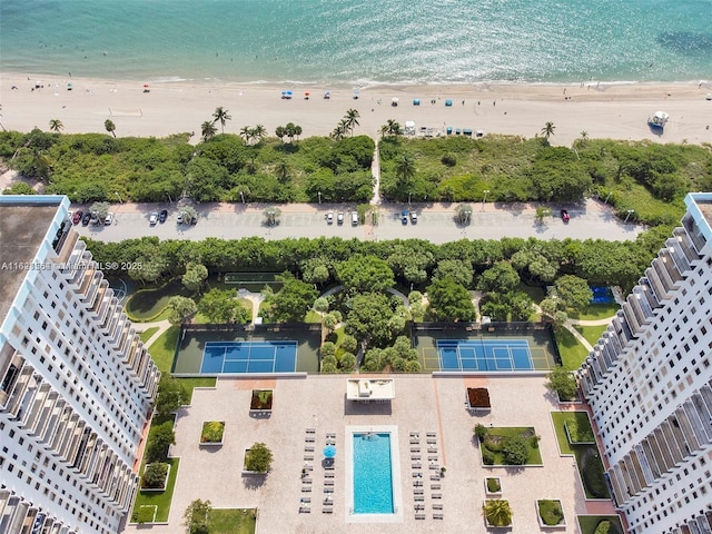 drone / aerial view with a beach view and a water view