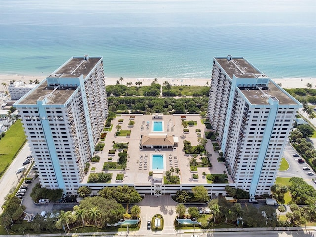 bird's eye view with a water view and a beach view