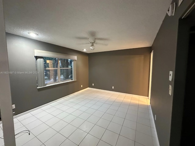 unfurnished room with ceiling fan and light tile patterned floors