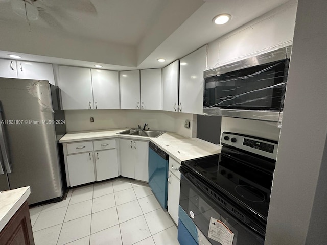 kitchen featuring light tile patterned flooring, sink, appliances with stainless steel finishes, and white cabinetry