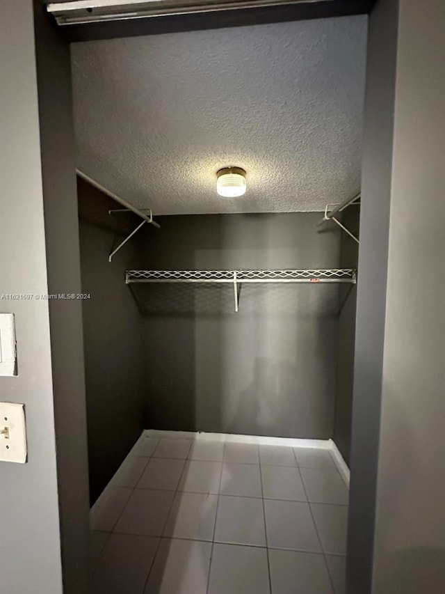 spacious closet with tile patterned floors