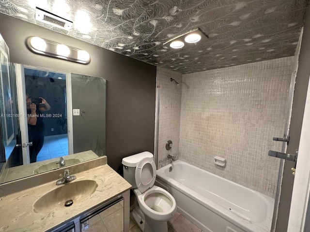 full bathroom featuring tile patterned floors, tiled shower / bath combo, and toilet