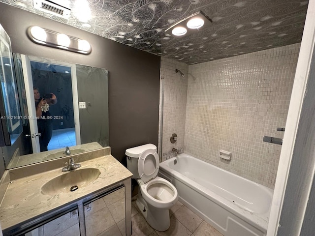 full bathroom featuring tiled shower / bath combo, tile patterned floors, toilet, and vanity