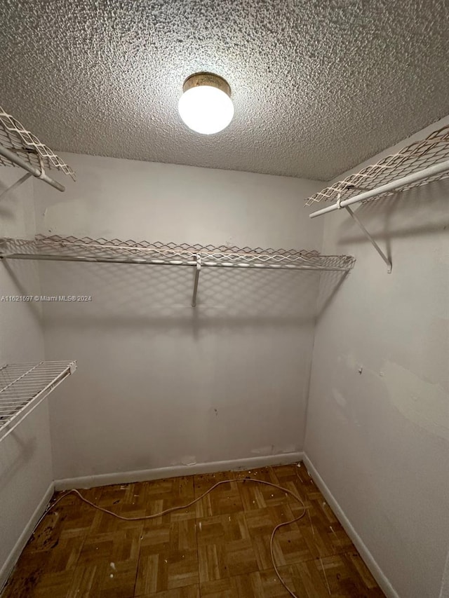 spacious closet with parquet flooring