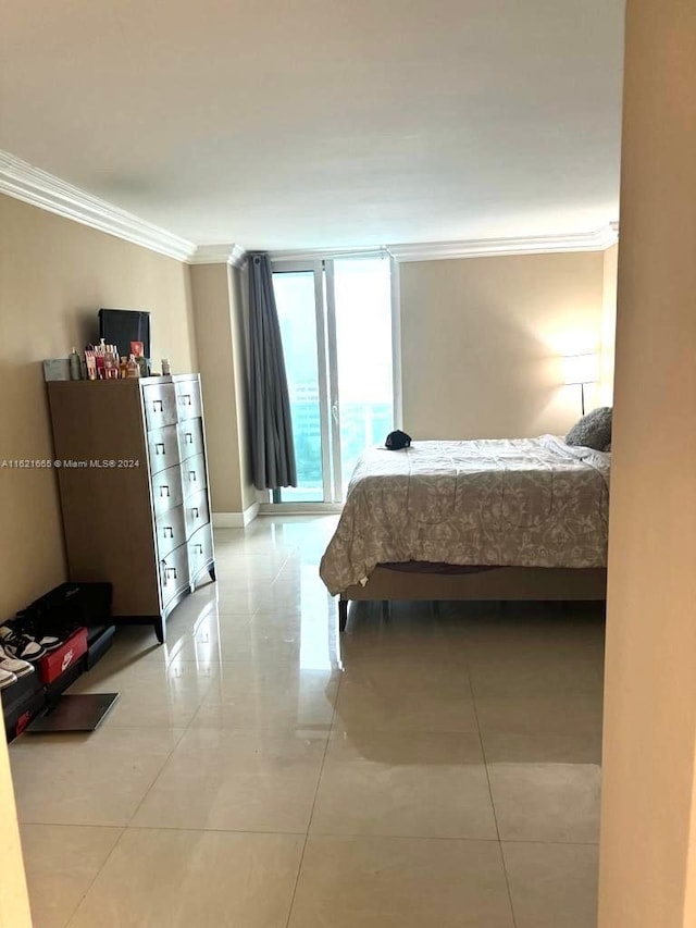 tiled bedroom featuring access to outside and ornamental molding