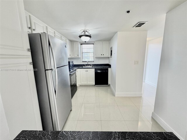 bathroom with tile patterned flooring, vanity, toilet, and an enclosed shower