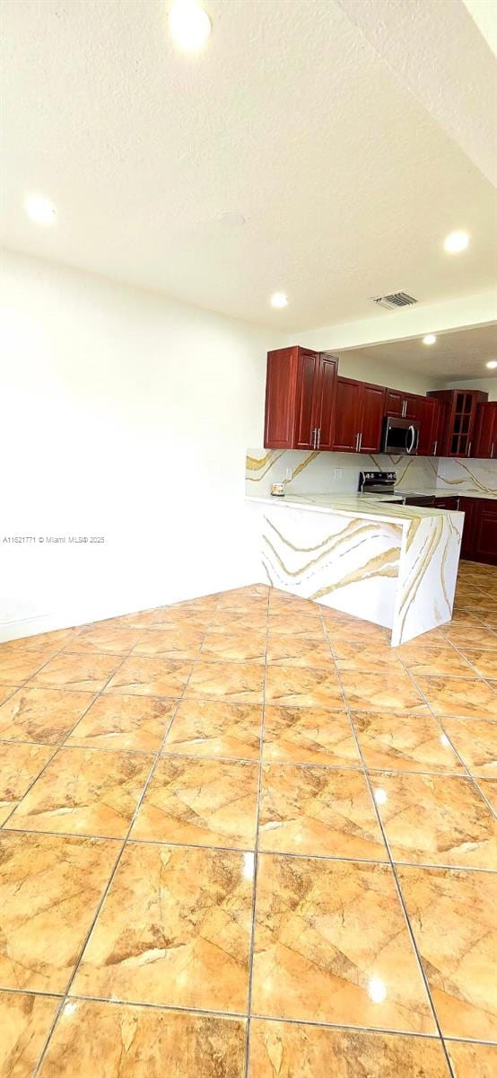 kitchen featuring a textured ceiling and tile patterned floors