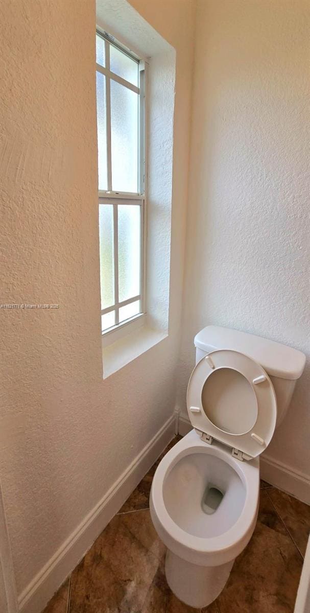 bathroom featuring tile patterned flooring and toilet