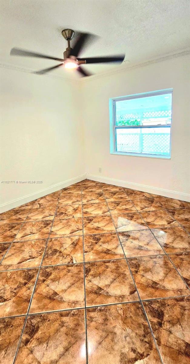 empty room featuring a textured ceiling and ceiling fan