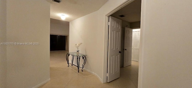 corridor featuring light tile patterned floors