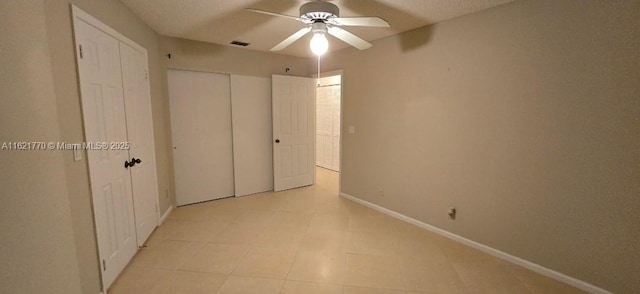 unfurnished bedroom featuring ceiling fan and a textured ceiling