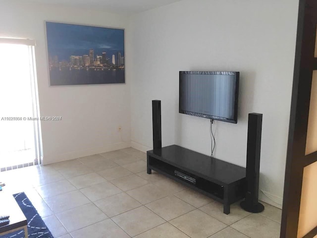 6707 N Kendall Dr Unit 115, Pinecrest, FL 33156 - unfurnished living room with light tile patterned floors, baseboards, and a wealth of natural light