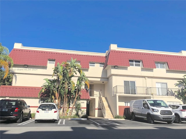6707 N Kendall Dr Unit 115, Pinecrest, FL 33156 - view of property with uncovered parking and stairway