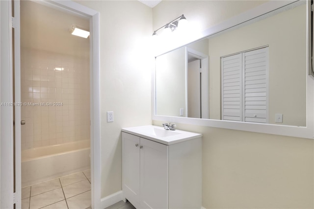 bathroom with vanity, tiled shower / bath combo, and tile patterned flooring