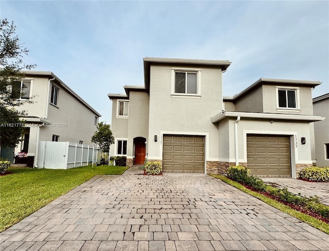 front facade with a garage and a front yard