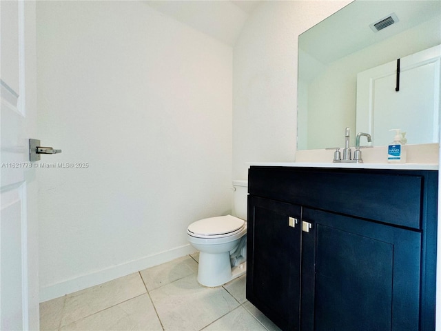 bathroom with tile patterned flooring, vanity, and toilet