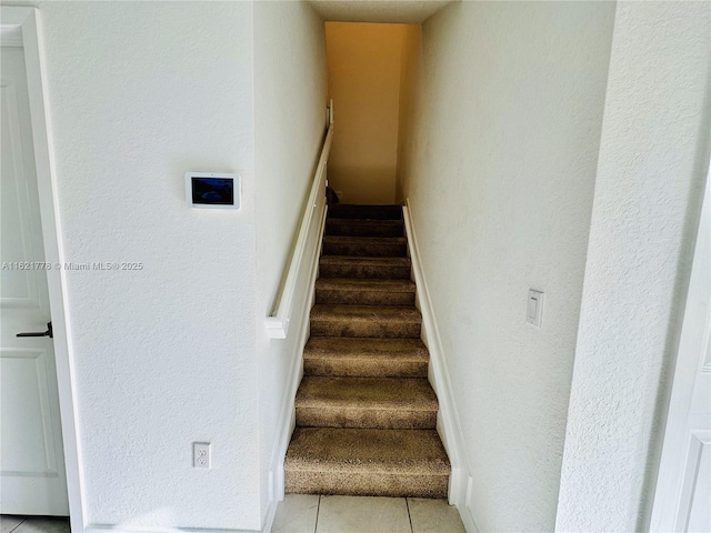 stairway with tile patterned flooring