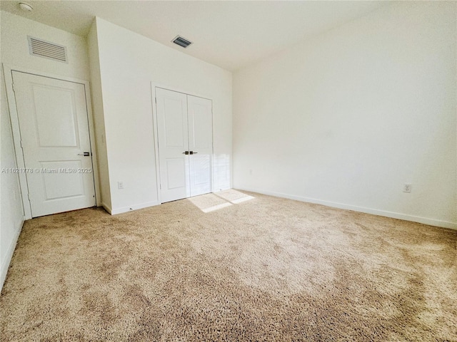 unfurnished bedroom with carpet flooring and a closet