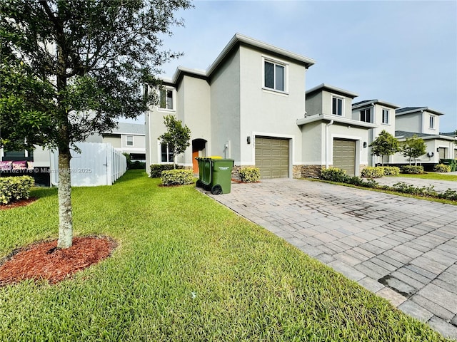 view of front of house with a garage and a front lawn