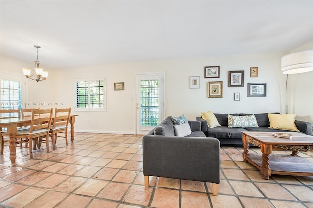 living room with a chandelier and light tile patterned floors