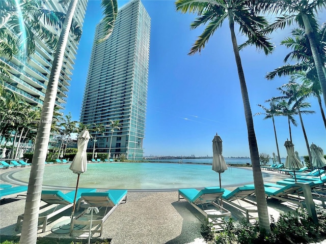 view of swimming pool featuring a water view