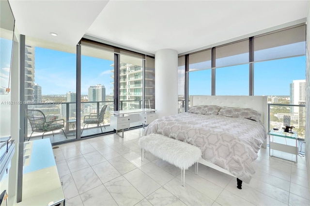 bedroom featuring multiple windows, access to exterior, and expansive windows