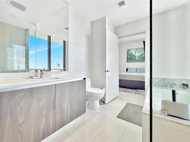 bathroom featuring tile patterned flooring, vanity, and toilet