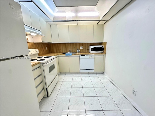 kitchen with white appliances and light tile patterned floors