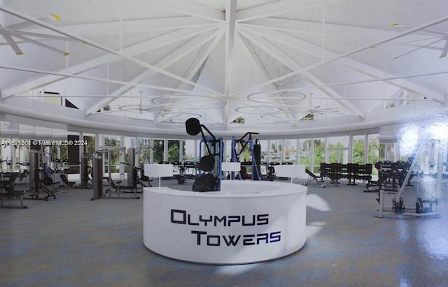 workout area featuring wood walls, a paneled ceiling, and ceiling fan