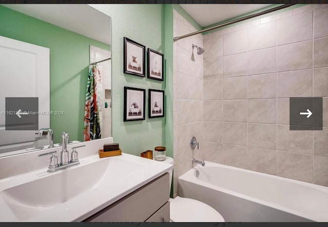 full bathroom with vanity, shower / tub combo, and toilet