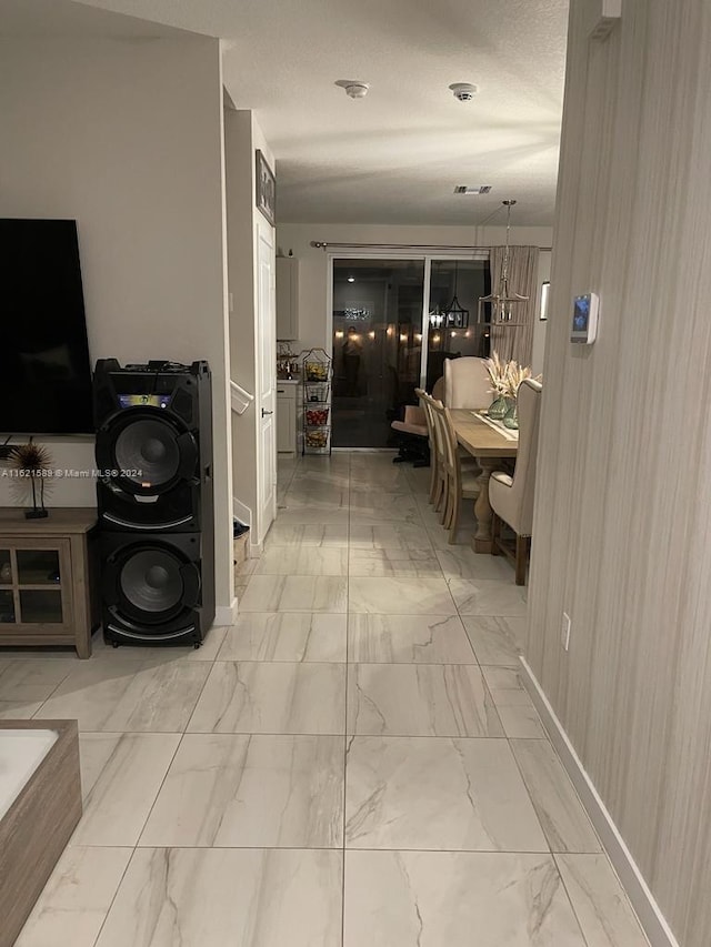 hallway with light tile patterned floors