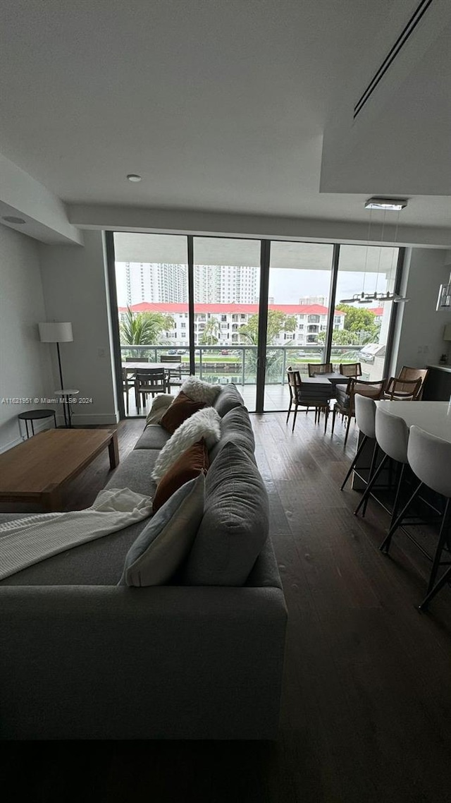 living room with expansive windows and dark hardwood / wood-style flooring