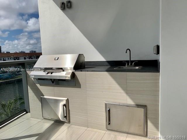 exterior space featuring a balcony, sink, an outdoor kitchen, and a grill