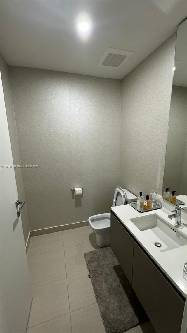 bathroom with tile patterned flooring, toilet, and vanity