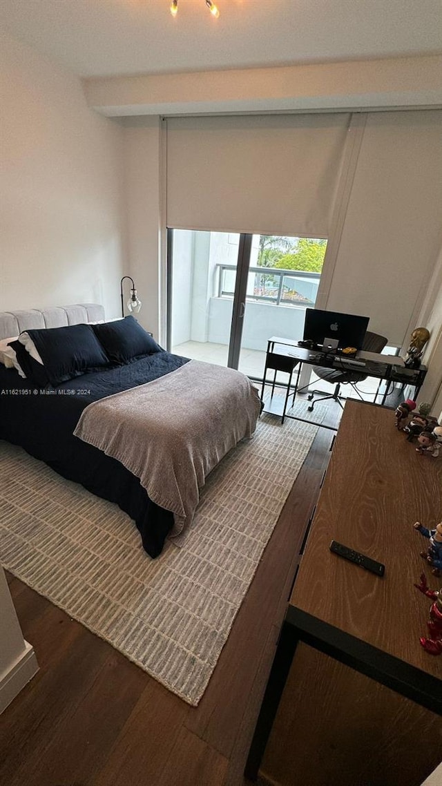 bedroom with dark wood-type flooring and beamed ceiling