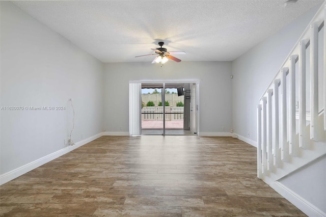 spare room with ceiling fan, hardwood / wood-style floors, and a textured ceiling