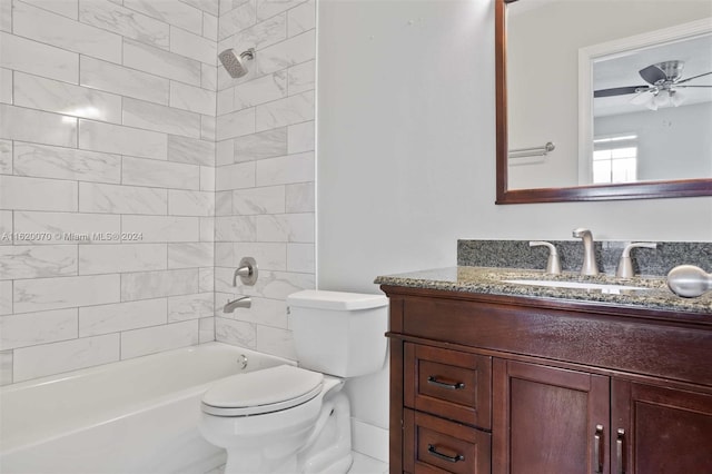 full bathroom with tiled shower / bath combo, vanity, ceiling fan, and toilet