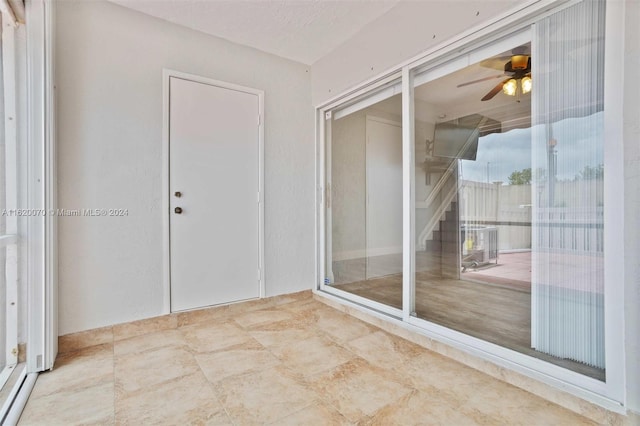 interior space featuring tile patterned floors and ceiling fan